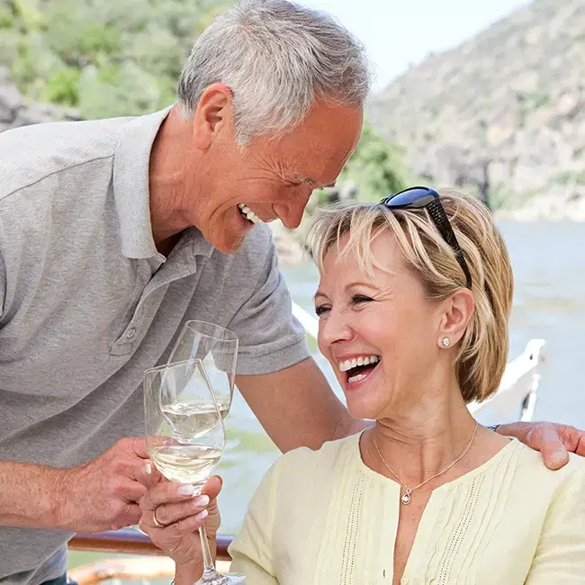 Happy retired couple drinking wine