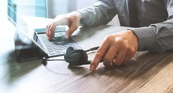 picture of hands on laptop with headphones